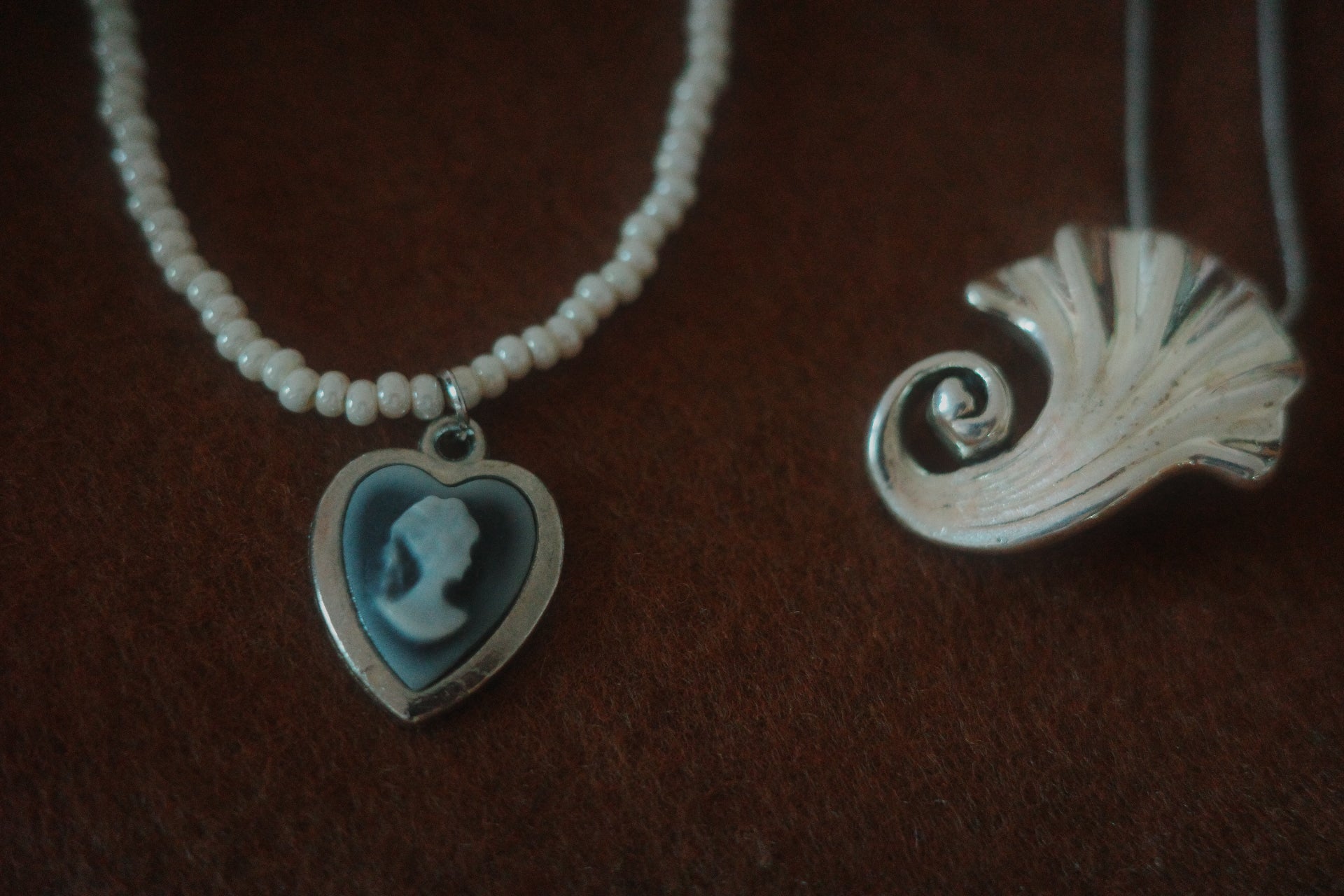 Portrait in Pearl Light – Glass Bead Necklace with Cameo Heart Pendant