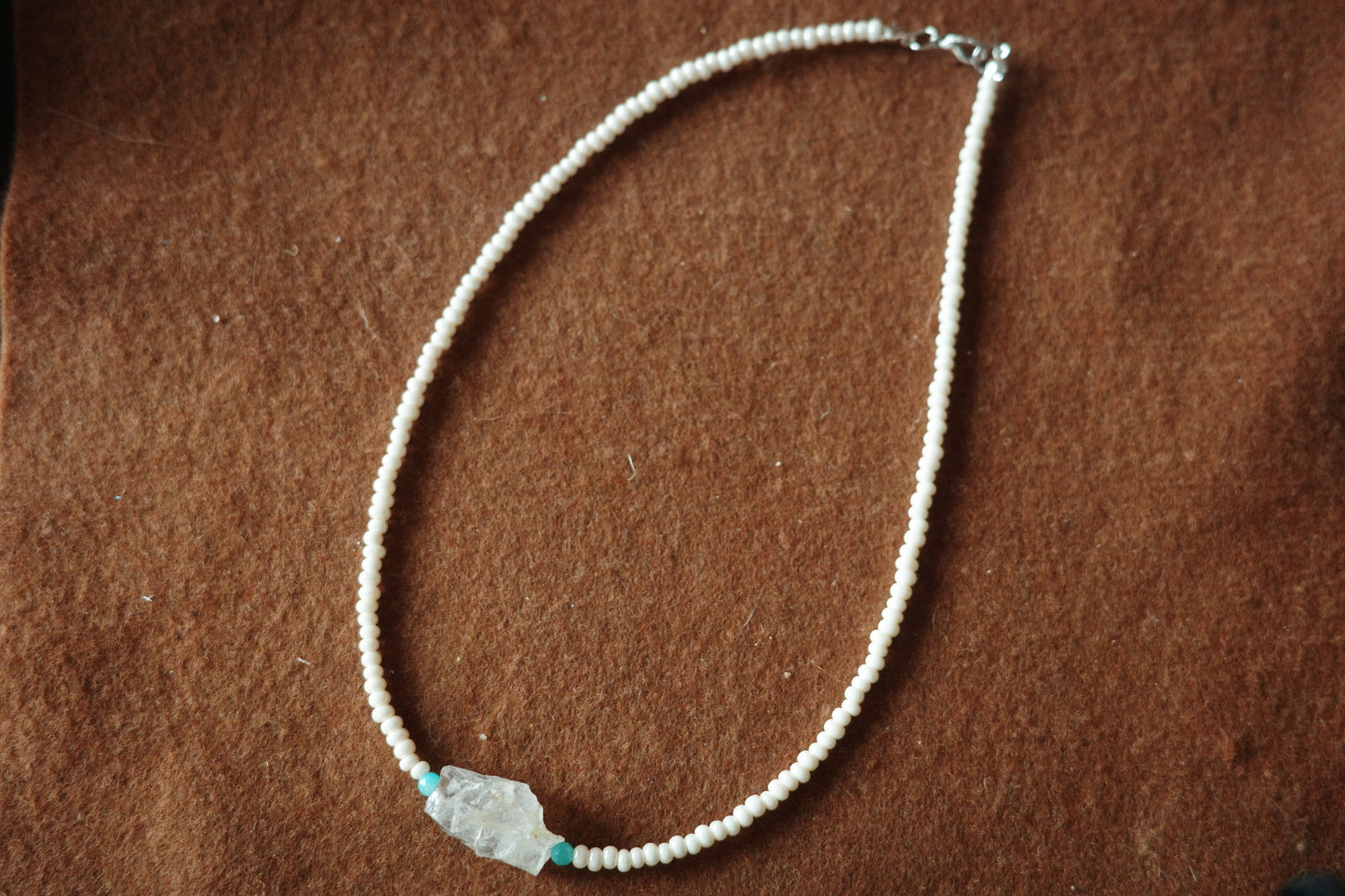 17-inch handmade necklace with a raw clear crystal centerpiece, Brazilian Amazonite beads, and small freshwater pearls on a sterling silver clasp