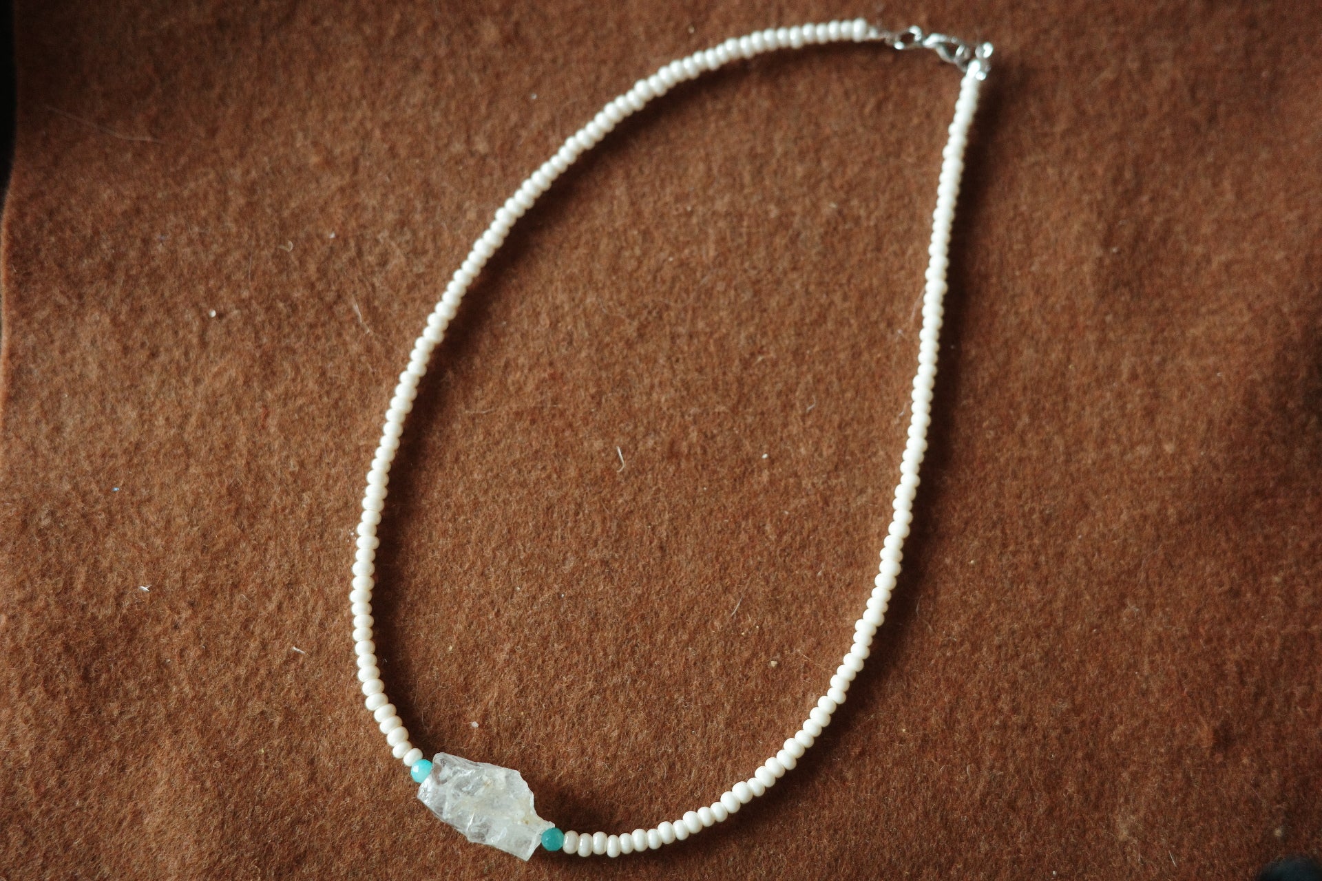 17-inch handmade necklace with a raw clear crystal centerpiece, Brazilian Amazonite beads, and small freshwater pearls on a sterling silver clasp