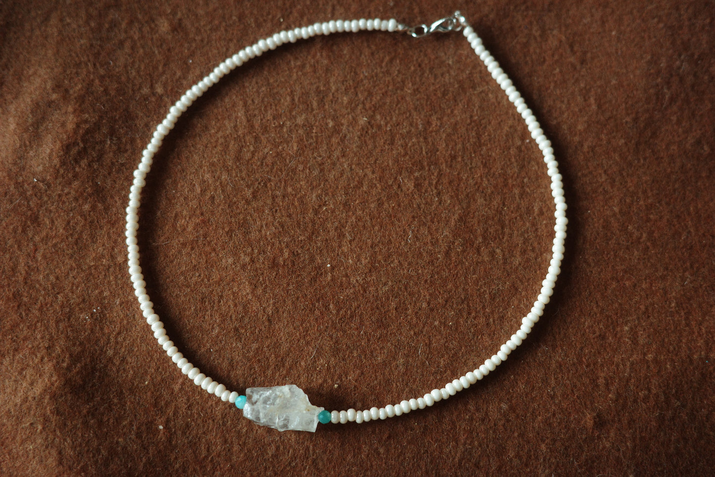 17-inch handmade necklace with a raw clear crystal centerpiece, Brazilian Amazonite beads, and small freshwater pearls on a sterling silver clasp