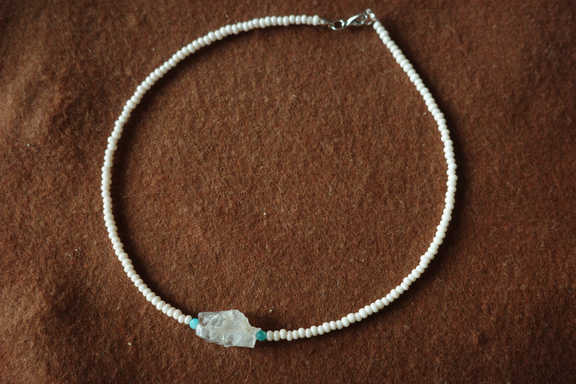 17-inch handmade necklace with a raw clear crystal centerpiece, Brazilian Amazonite beads, and small freshwater pearls on a sterling silver clasp