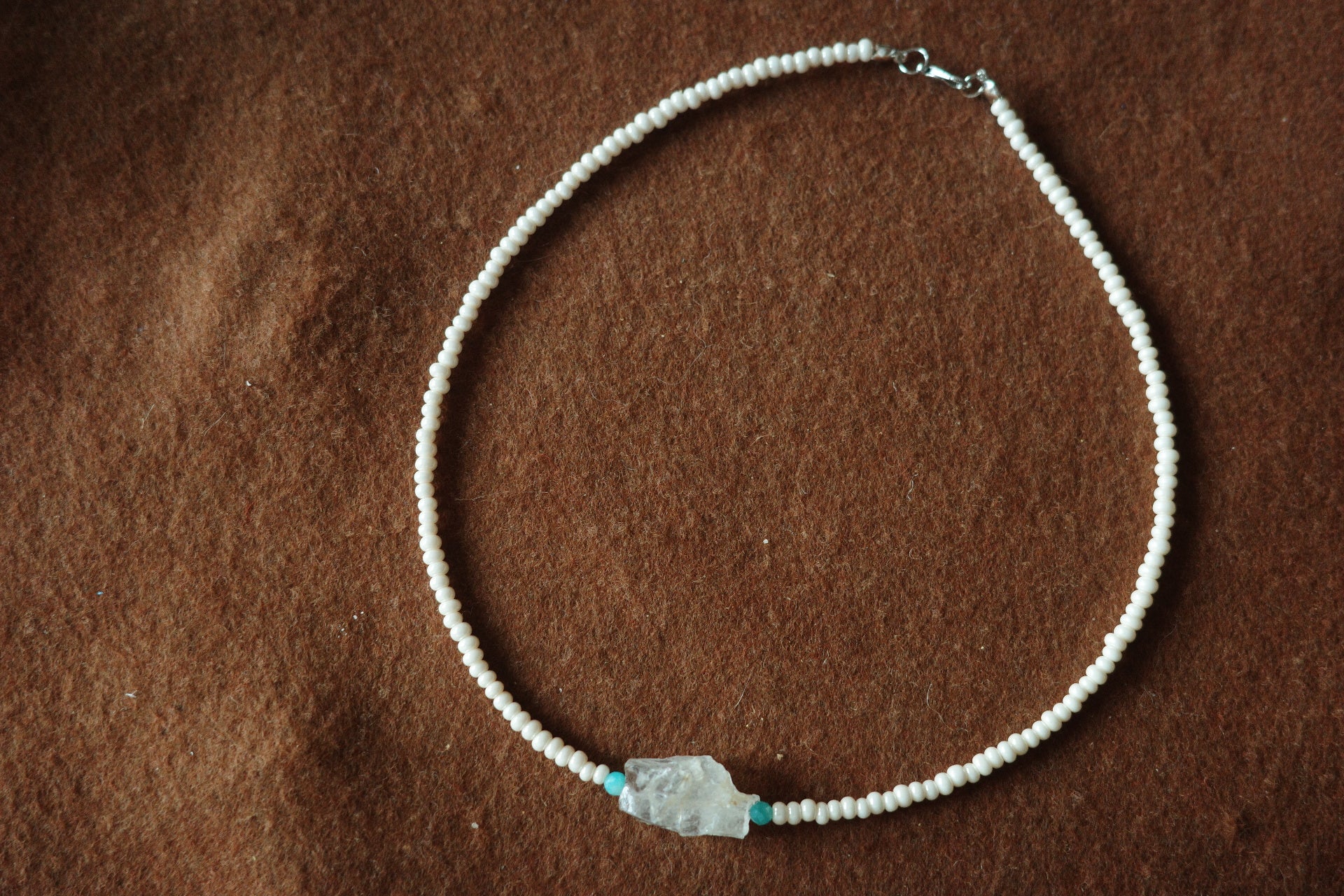17-inch handmade necklace with a raw clear crystal centerpiece, Brazilian Amazonite beads, and small freshwater pearls on a sterling silver clasp